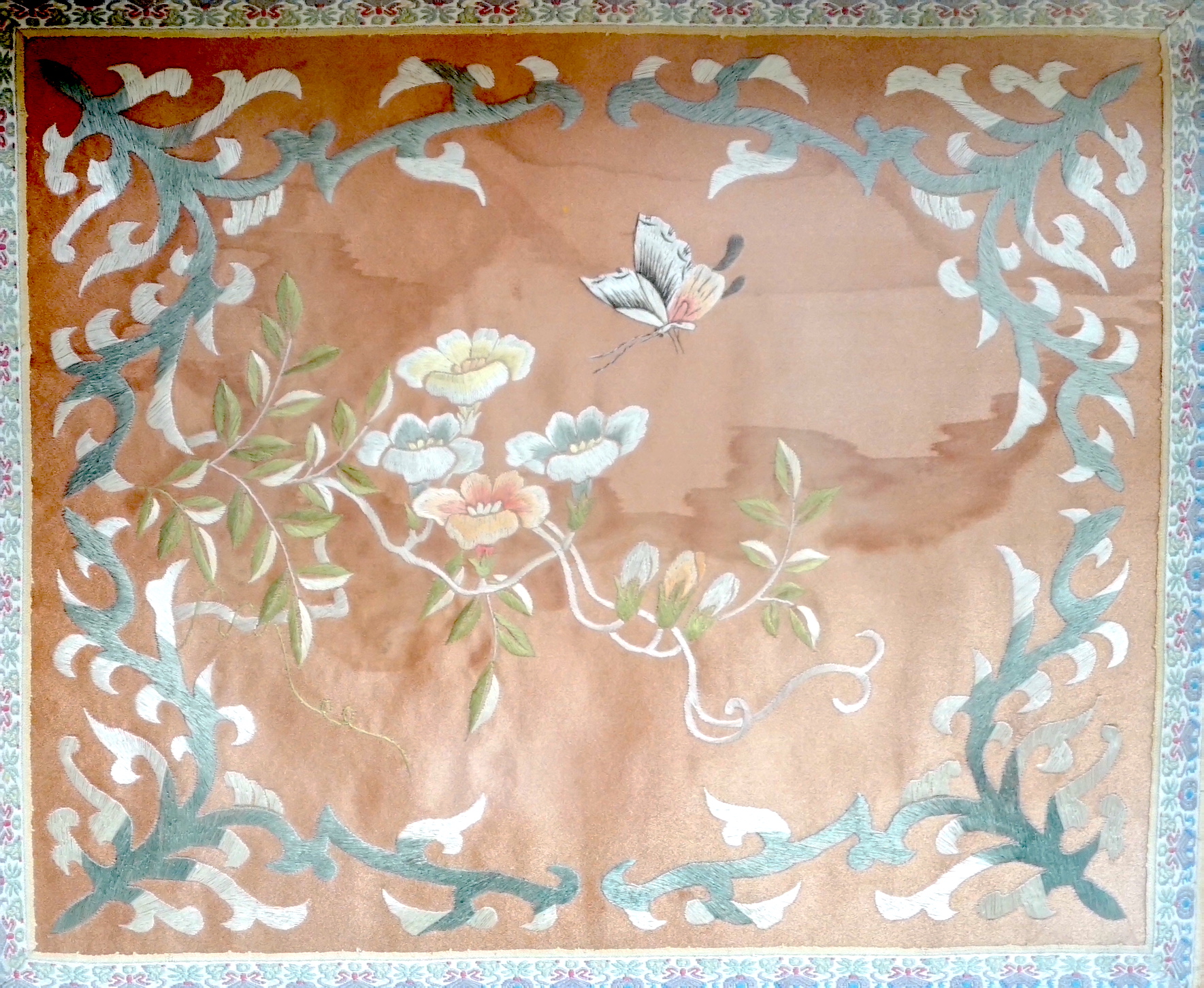 A Chinese silk panel embroidered with flowers and butterflies, framed, 43cm x 38cm